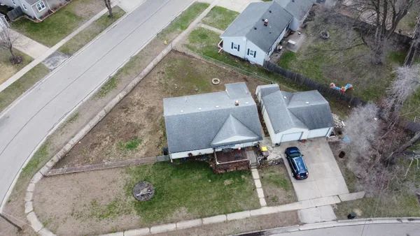 an aerial view of a house with a yard