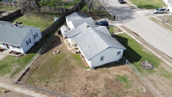 an aerial view of a house with a yard