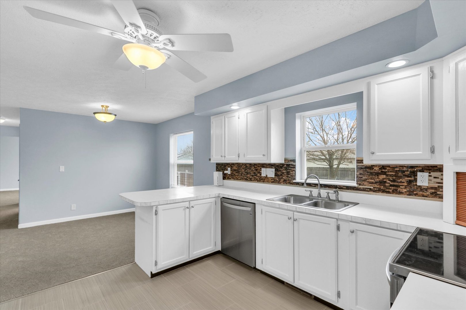 2302 Pheasant Ridge Road Mahomet, IL 61853 - Photo 11 of 31 a kitchen that has a sink a stove and cabinets