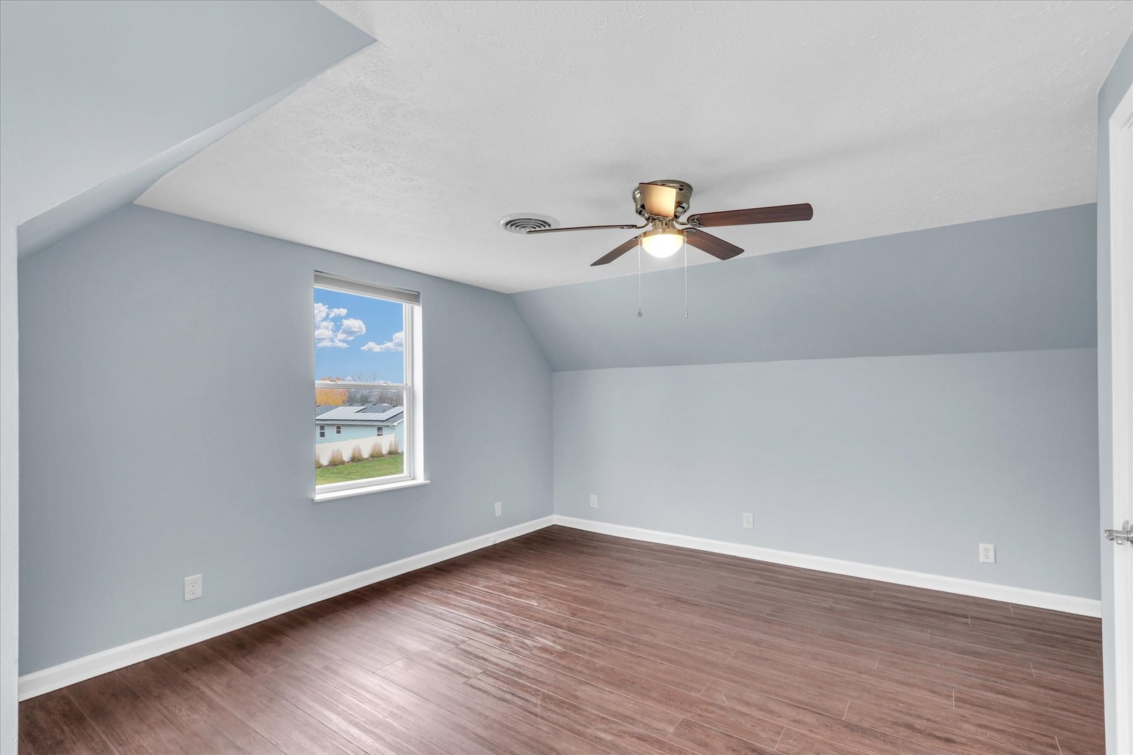 2302 Pheasant Ridge Road Mahomet, IL 61853 - Photo 20 of 31 an empty room with wooden floor fan and windows