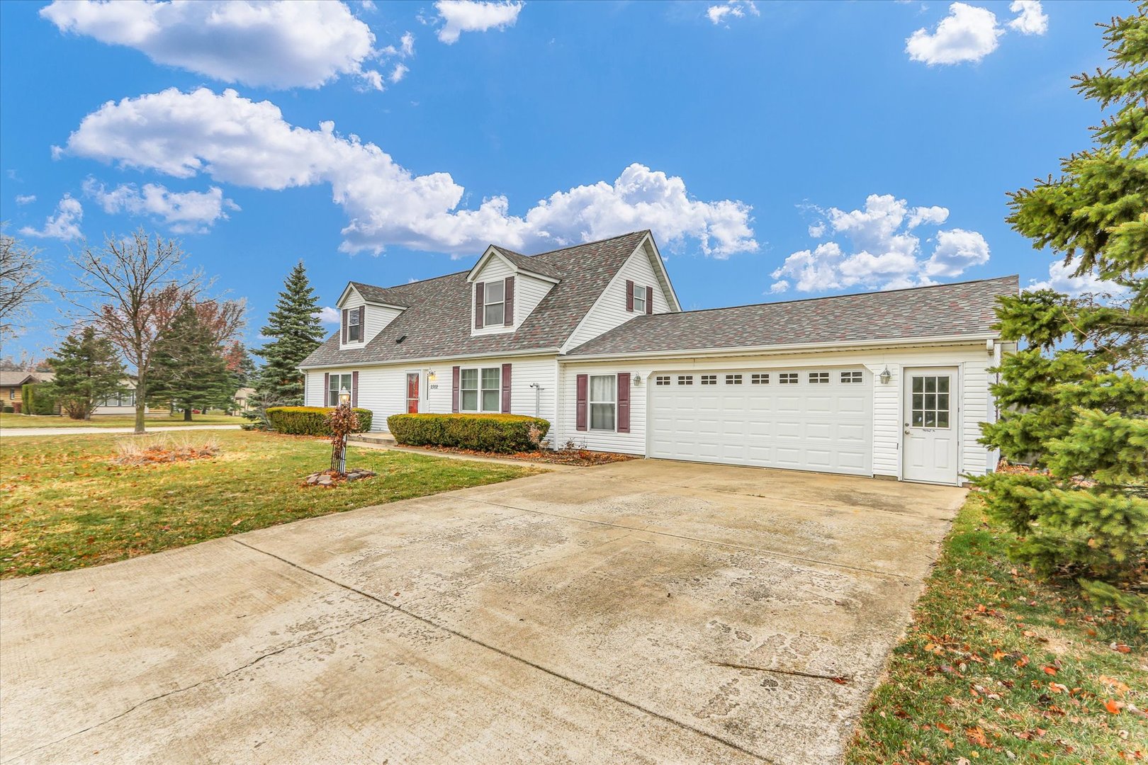 2302 Pheasant Ridge Road Mahomet, IL 61853 - Photo 2 of 31 a view of a house with a yard and a garage