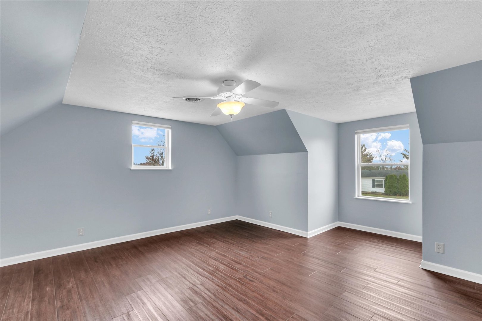 2302 Pheasant Ridge Road Mahomet, IL 61853 - Photo 22 of 31 an empty room with wooden floor and windows