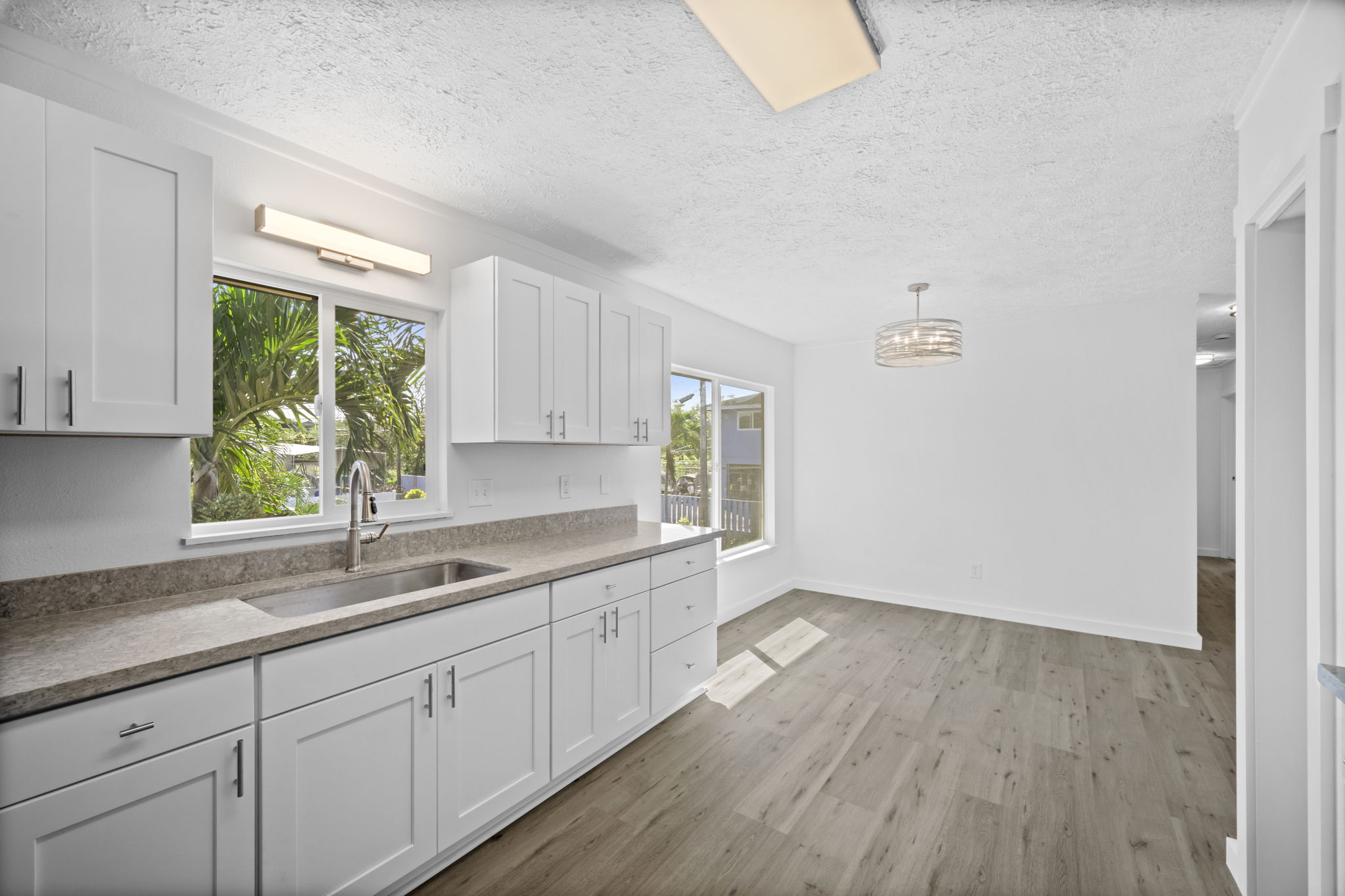 4431 Iona Road Hanapepe, HI 96705 - Photo 4 of 20 a kitchen with a sink wooden floor and window