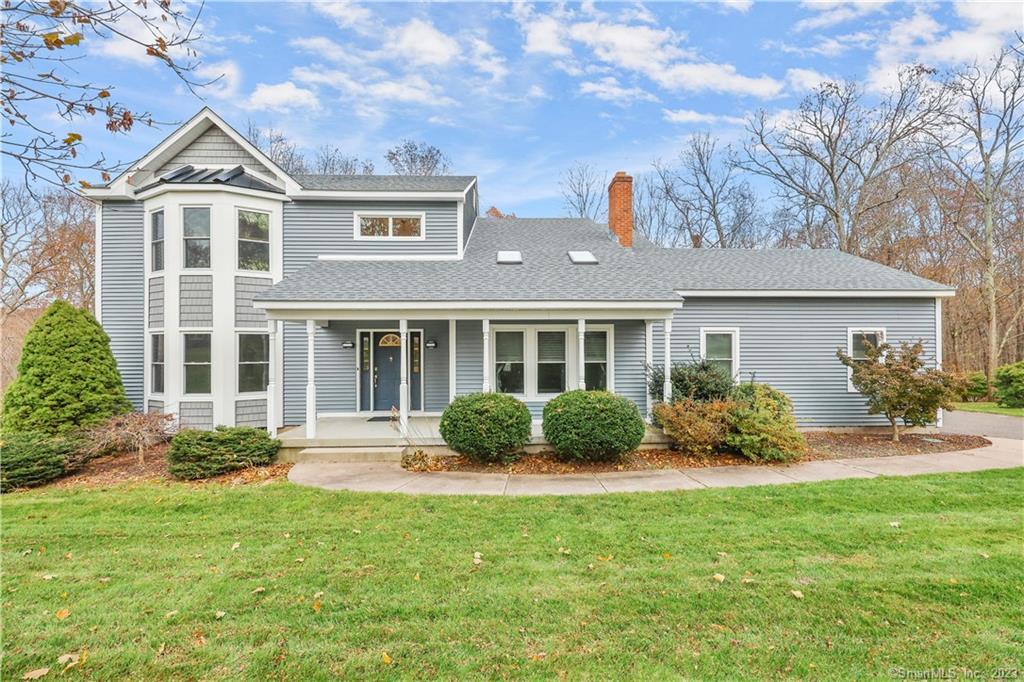 a front view of a house with yard and outdoor seating