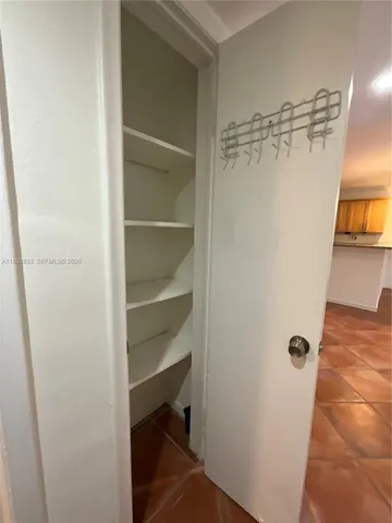 a view of a room with wooden floor and a chair