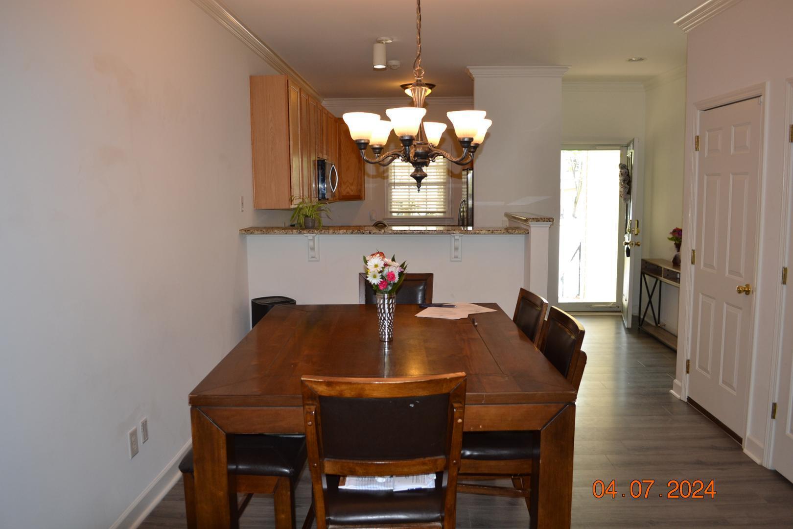 4506 Mistiflower Drive Raleigh, NC 27606 - Photo 13 of 27 a view of a dining room with a table and chairs