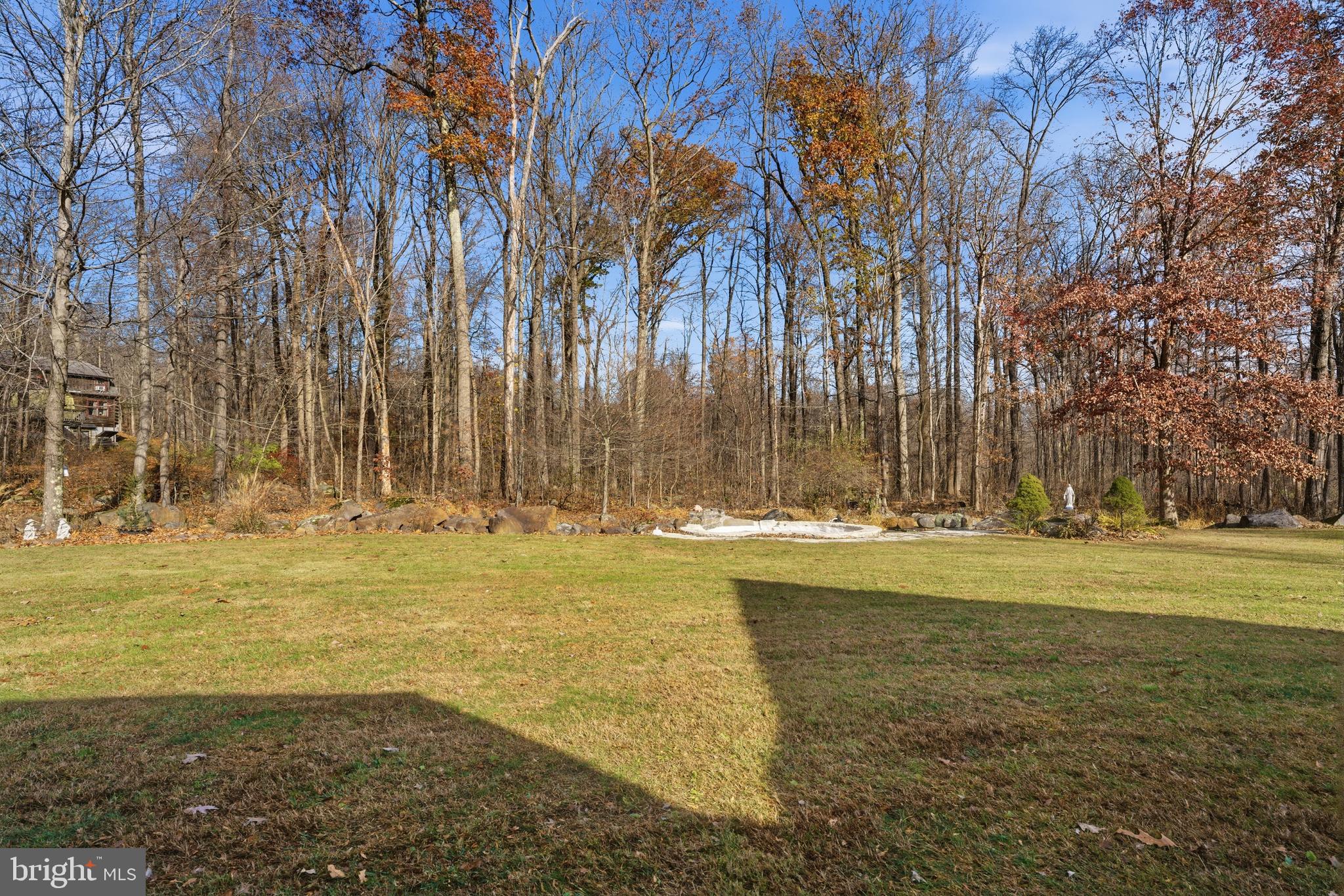 52 Harrisburg School Road Quakertown, PA 18951 - Photo 4 of 32 a view of a swimming pool with an outdoor space and seating area