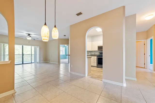 a view of a kitchen with a sink and an entryway