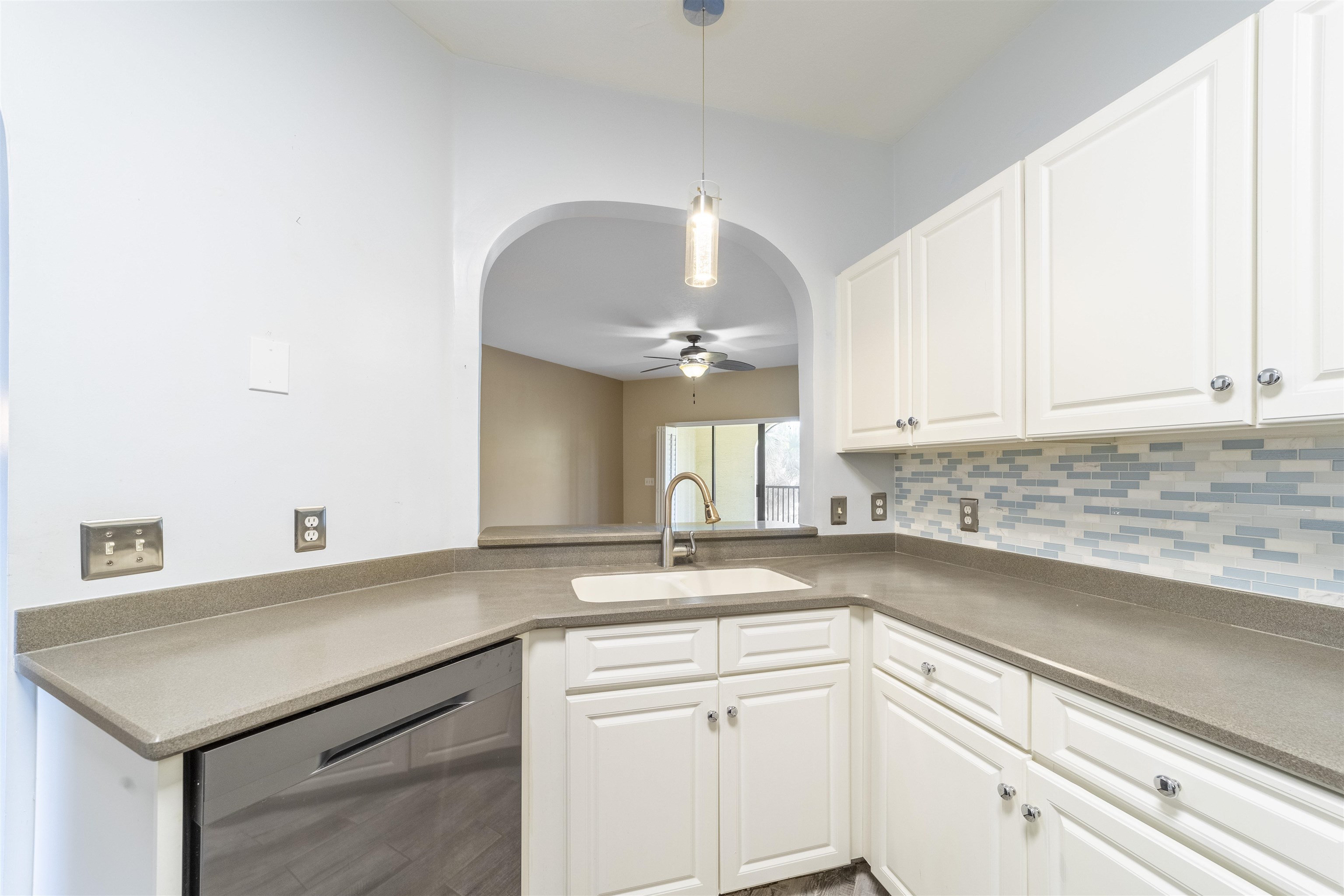 3225 Haley Pointe Road St. Augustine, FL 32084 - Photo 22 of 35 a kitchen with granite countertop a sink white cabinets and a granite counter tops