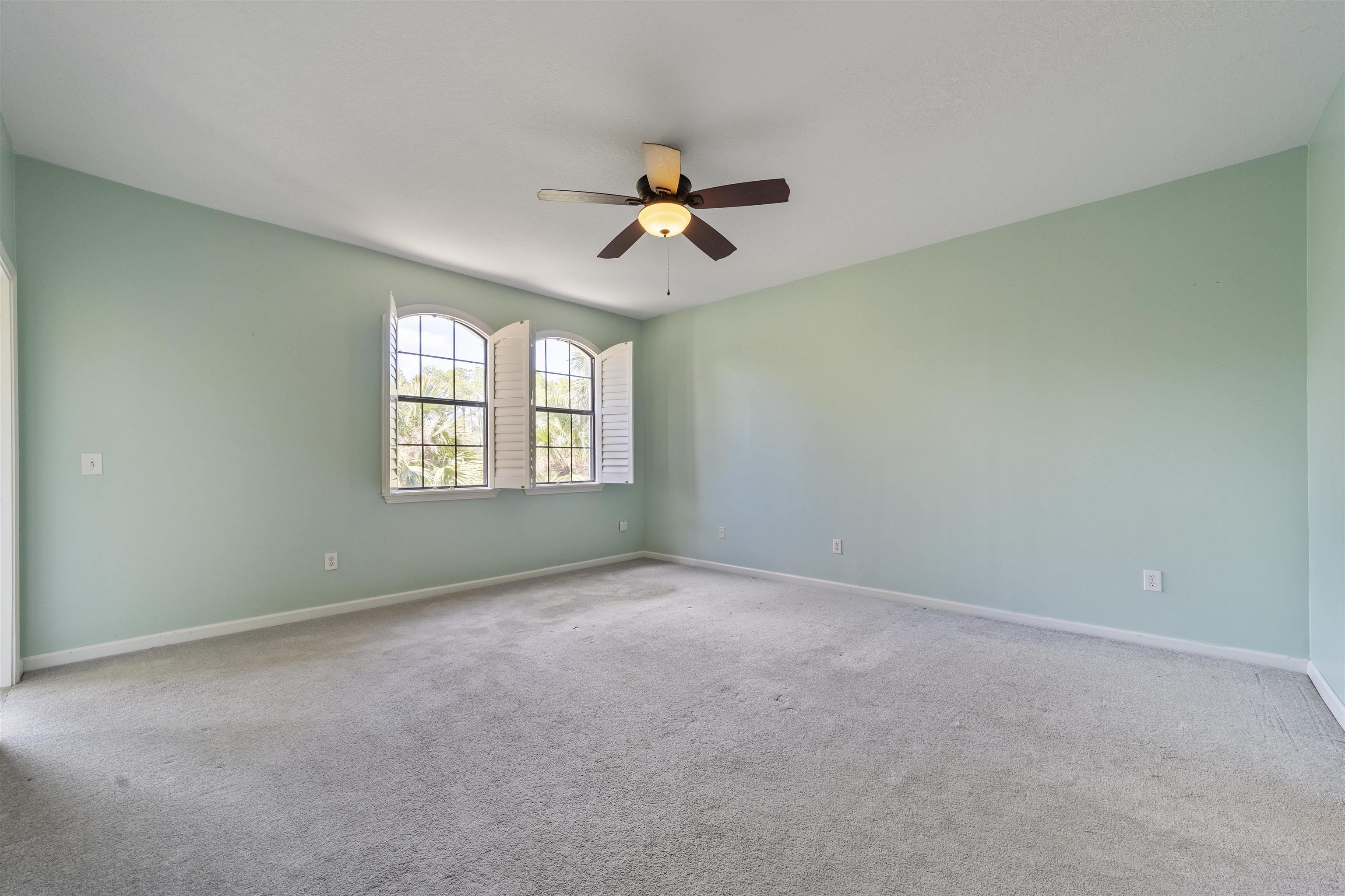 3225 Haley Pointe Road St. Augustine, FL 32084 - Photo 26 of 35 an empty room with windows and fan chandelier fan