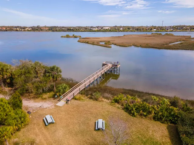 an aerial view of a house with a swimming pool patio and outdoor seating