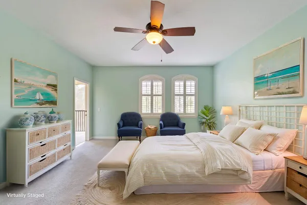 a spacious bedroom with two beds and a large window