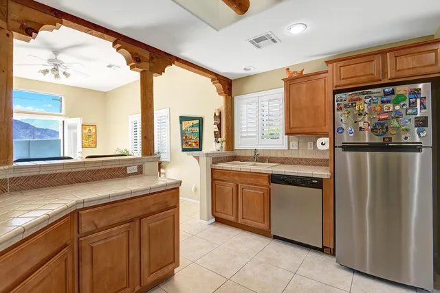 a kitchen with stainless steel appliances granite countertop a refrigerator and a sink