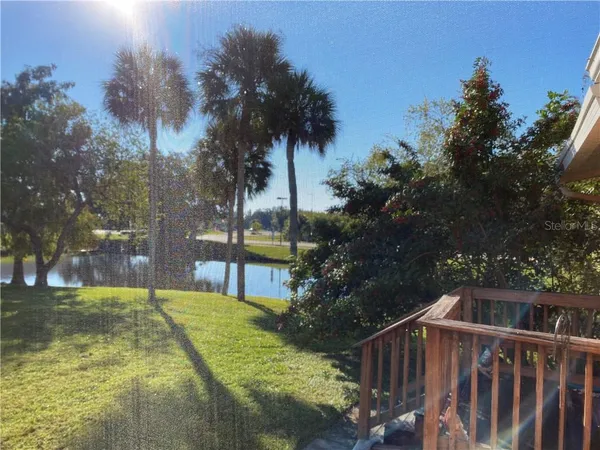 a view of backyard with swimming pool and green space
