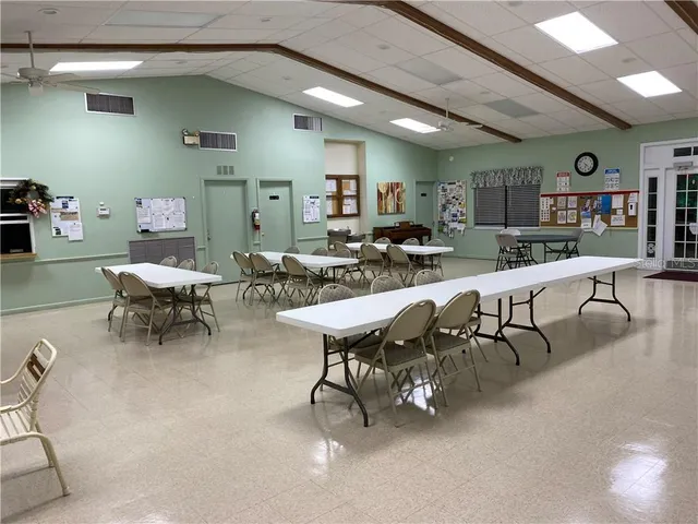 a living room with furniture and a book shelf