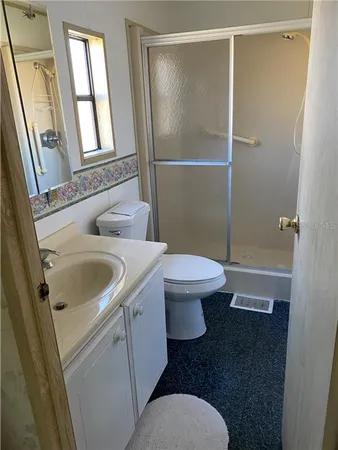 a white toilet sitting next to a bathroom sink