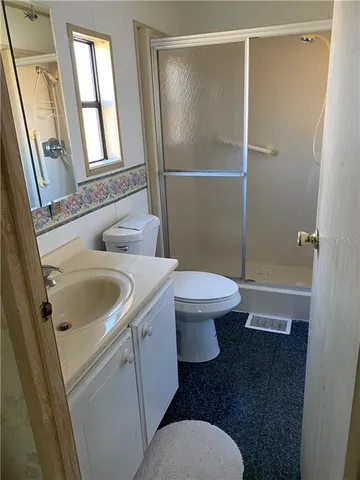 a white toilet sitting next to a bathroom sink