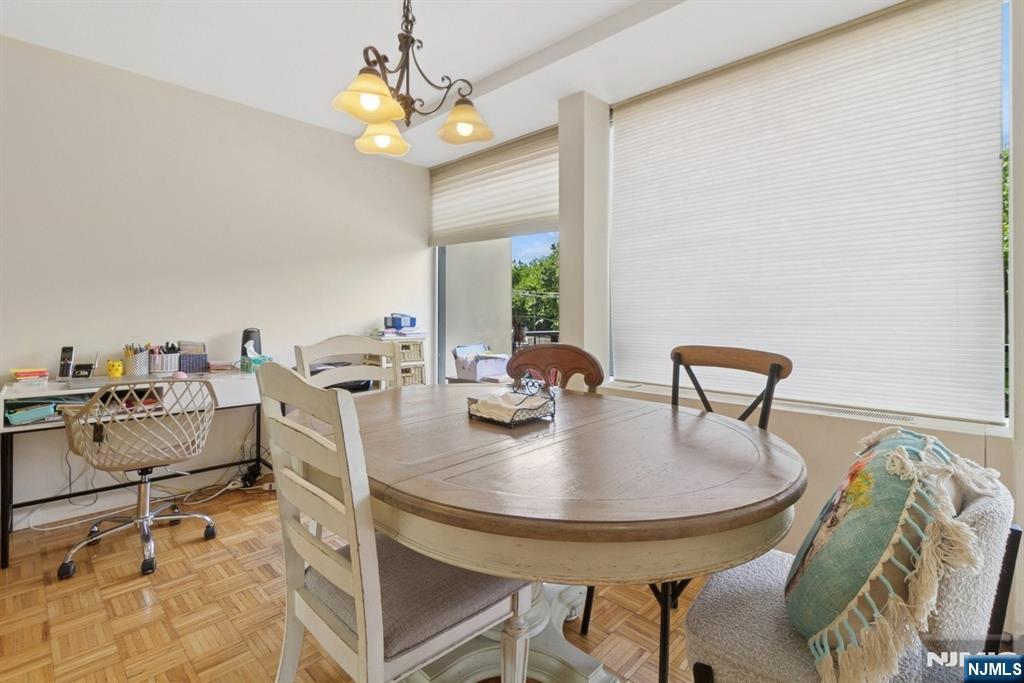 4 Horizon Road, Unit 416 Fort Lee, NJ 07024 - Photo 15 of 29 a dining room with furniture and chandelier