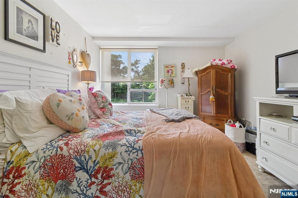 4 Horizon Road, Unit 416 Fort Lee, NJ 07024 - Photo 21 of 29 a bed sitting in a bedroom next to a window