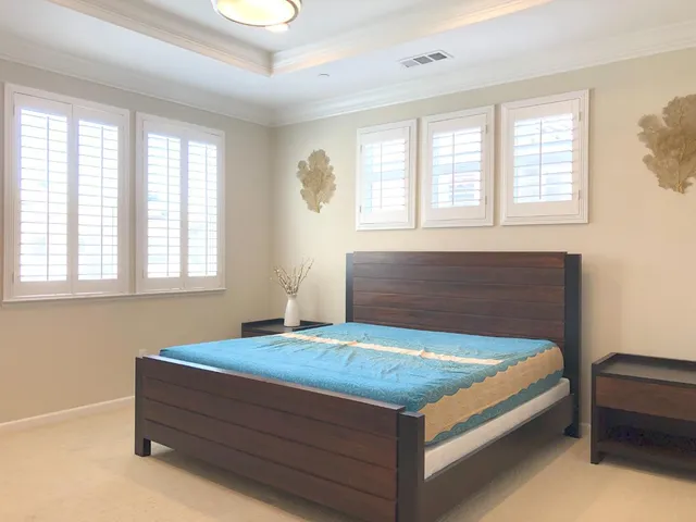 a bedroom with a bed and window