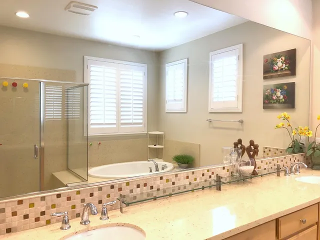 a bathroom with a tub sink and mirror