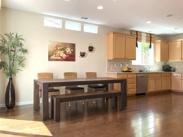 a kitchen with granite countertop a stove a sink and a refrigerator