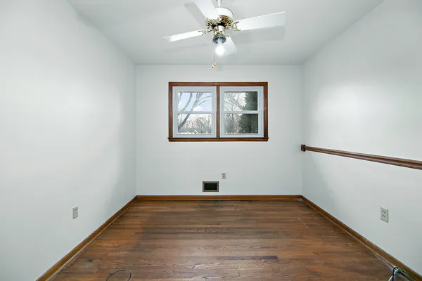 a room with a window and a ceiling fan