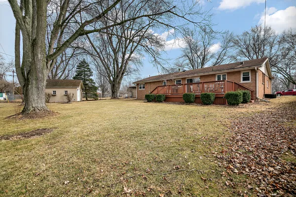 a view of a house with a yard and trees