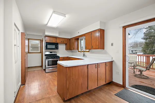 a kitchen with stainless steel appliances granite countertop a refrigerator a sink and a stove