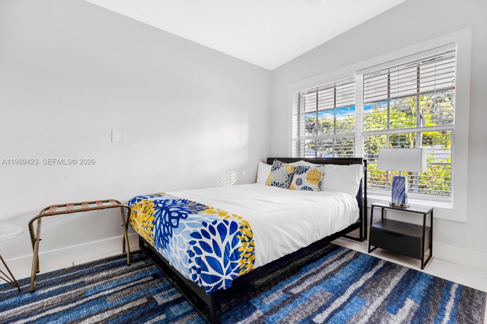 38 Miami Gardens Road West Park, FL 33023 - Photo 14 of 30 a bedroom with a bed next to a window