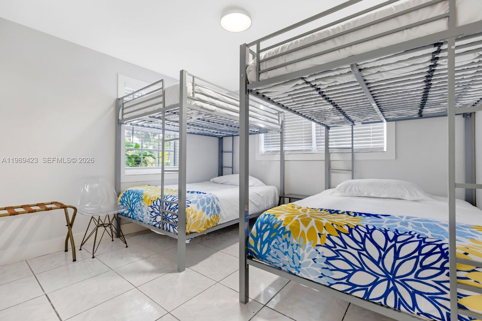 38 Miami Gardens Road West Park, FL 33023 - Photo 17 of 30 a bed room with furniture and a chandelier