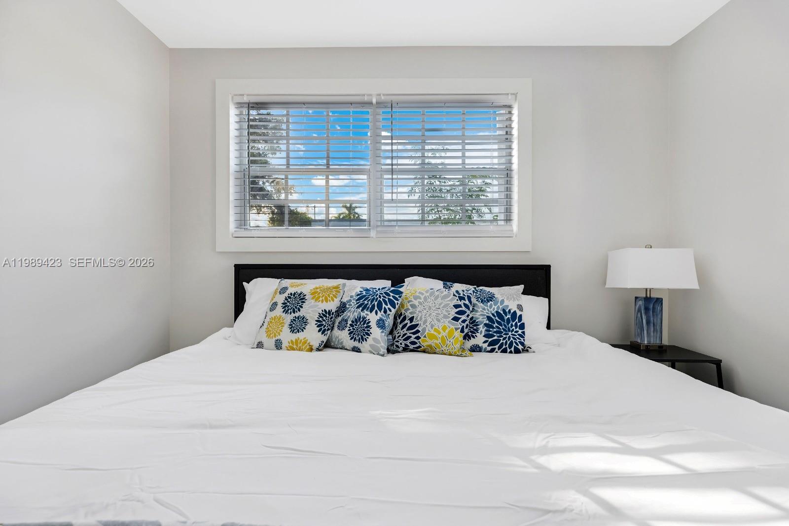 38 Miami Gardens Road West Park, FL 33023 - Photo 19 of 30 a bed sitting in a bedroom next to a window