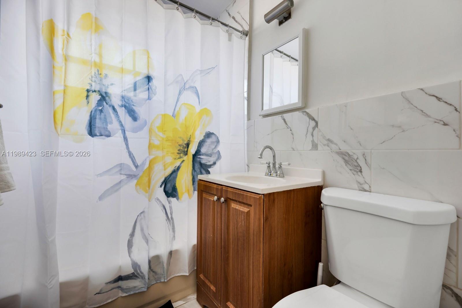 38 Miami Gardens Road West Park, FL 33023 - Photo 21 of 30 a bathroom with a sink mirror vanity and toilet