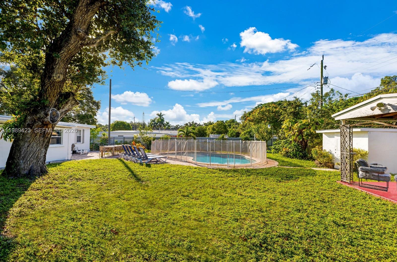 38 Miami Gardens Road West Park, FL 33023 - Photo 25 of 30 a view of a swimming pool with a patio