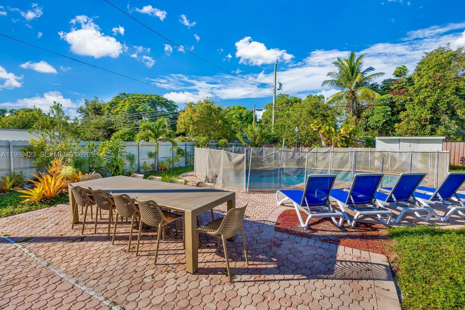 38 Miami Gardens Road West Park, FL 33023 - Photo 26 of 30 a view of a patio with table and chairs potted plants with wooden floor