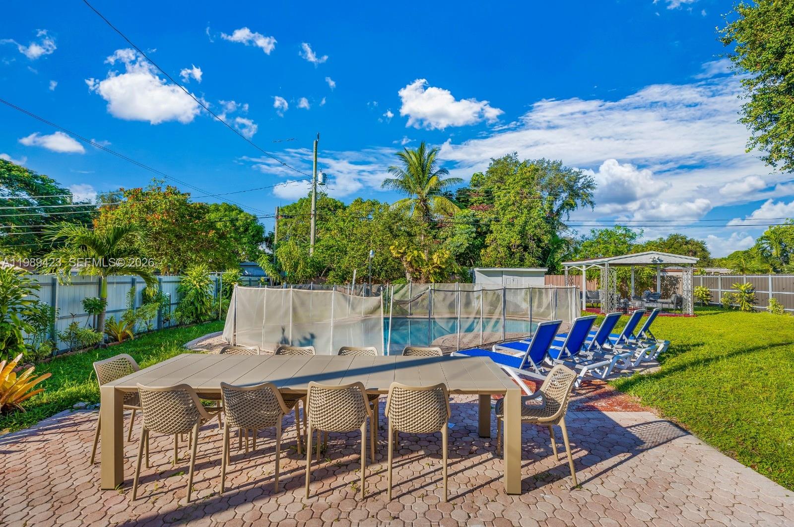 38 Miami Gardens Road West Park, FL 33023 - Photo 29 of 30 a view of an chairs and tables in the patio