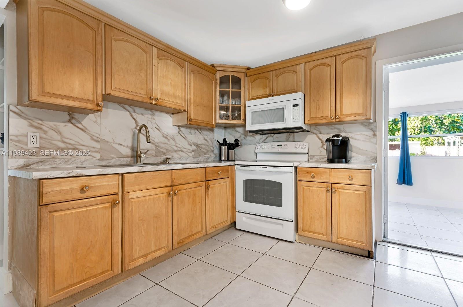 38 Miami Gardens Road West Park, FL 33023 - Photo 6 of 30 a kitchen with cabinets appliances and a sink