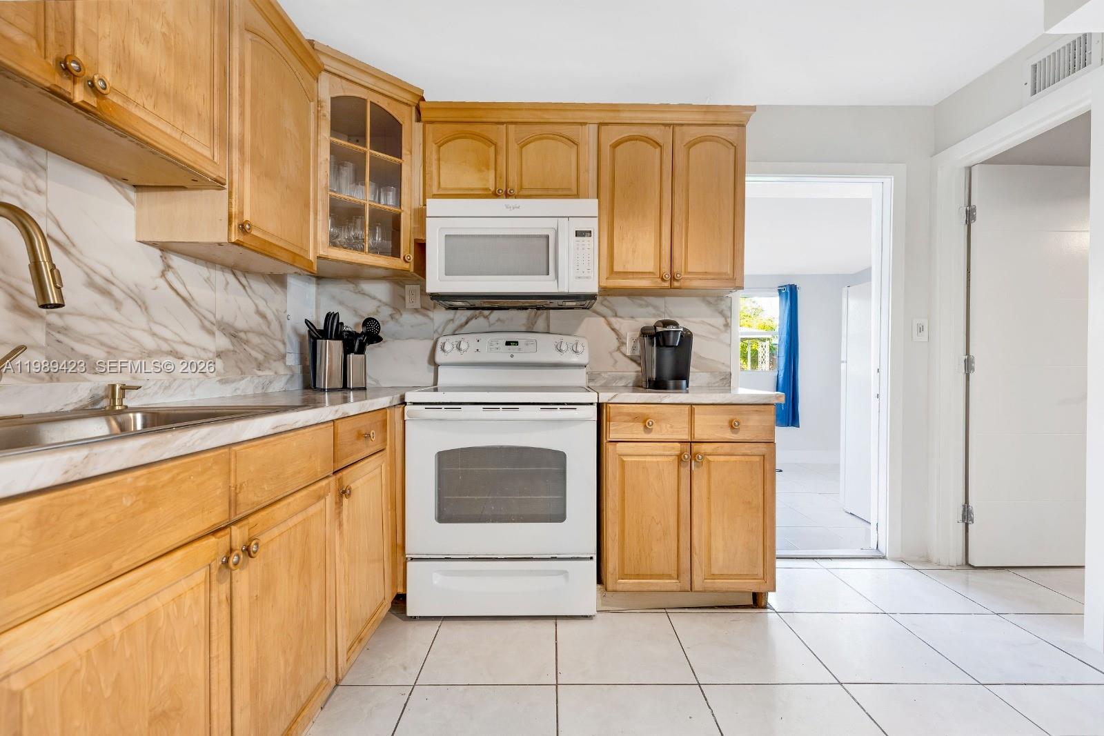 38 Miami Gardens Road West Park, FL 33023 - Photo 7 of 30 a kitchen with stainless steel appliances granite countertop a sink and cabinets