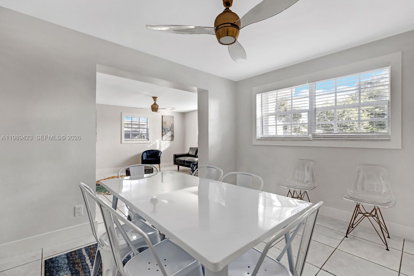 38 Miami Gardens Road West Park, FL 33023 - Photo 10 of 30 a view of a dining room with furniture and a chandelier