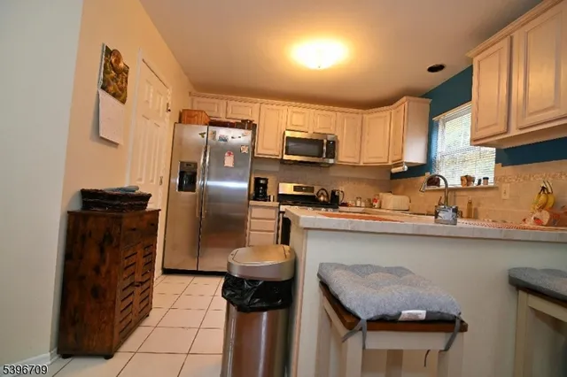 a kitchen with stainless steel appliances a refrigerator a sink a stove and cabinets