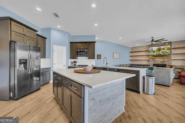 a kitchen with a refrigerator a stove and a sink