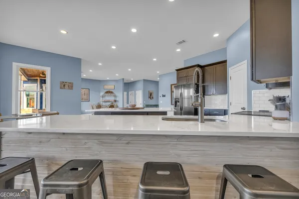 a kitchen with a refrigerator and cabinets