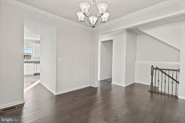 a view of a dining room with furniture wooden floor and chandelier