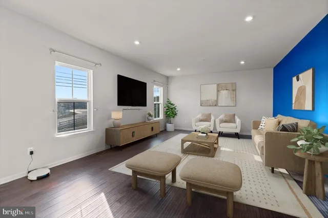 a kitchen with stainless steel appliances a refrigerator and wooden floor