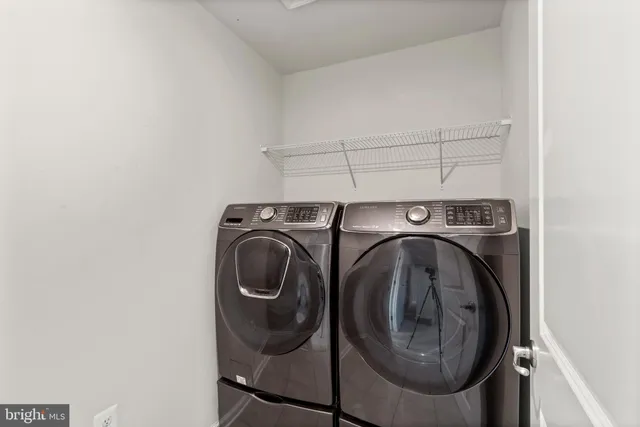 a spacious bedroom with a large bed couch and windows