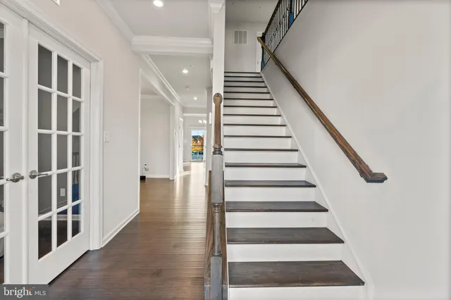 a view of entryway and hall with wooden floor