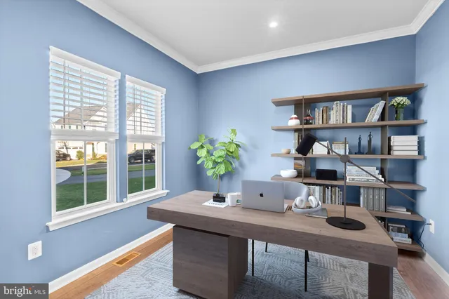an empty room with wooden floor chandelier and windows