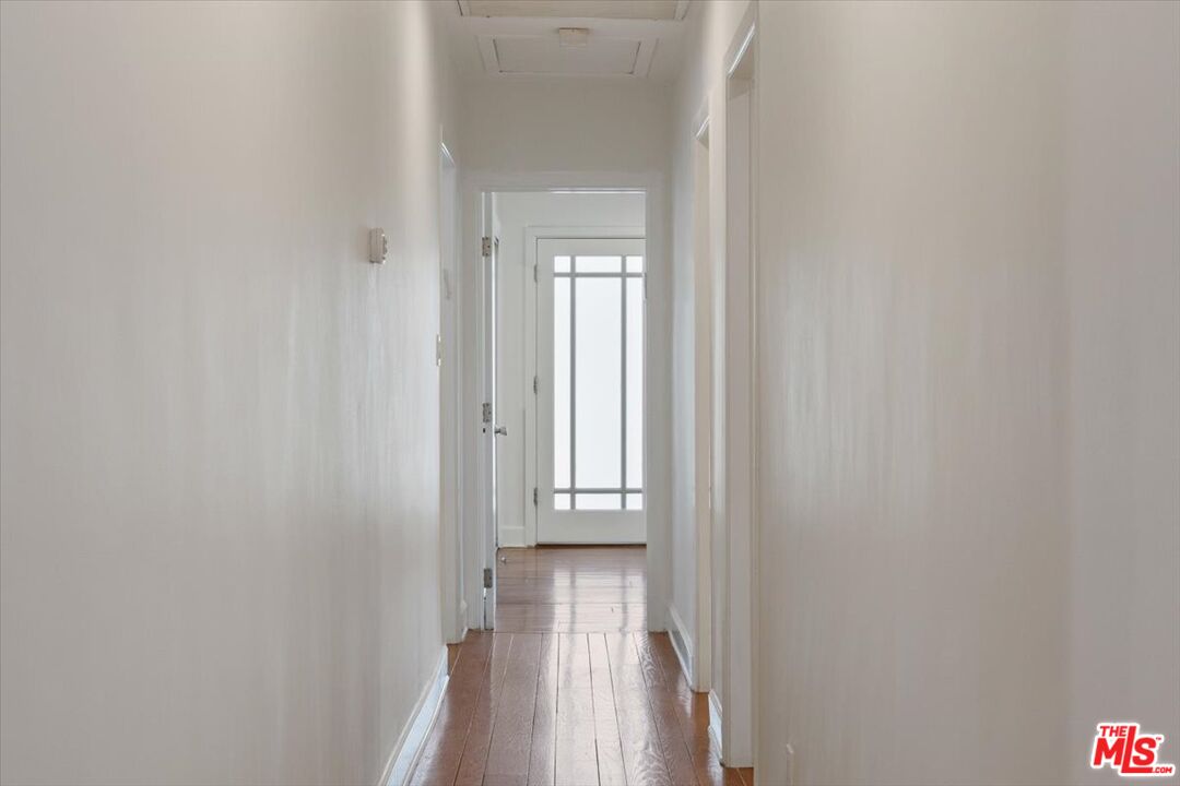 14041 Roblar Road Sherman Oaks, CA 91423 - Photo 20 of 47 a view of a hallway with wooden floor and a mirror