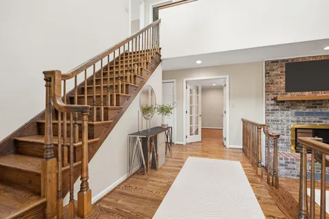 a view of entryway and hall with wooden floor