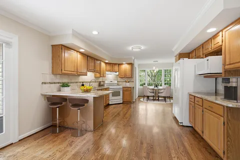 a kitchen with a sink a counter top space and stainless steel appliances